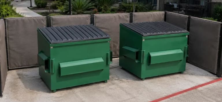 Enclosure T4, two green dumpsters behind a screened fence
